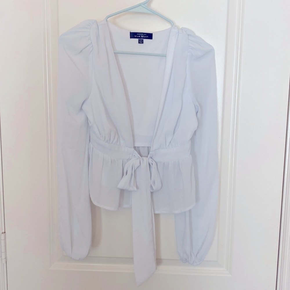 White front tie crop top with peplum detail and long sleeves!